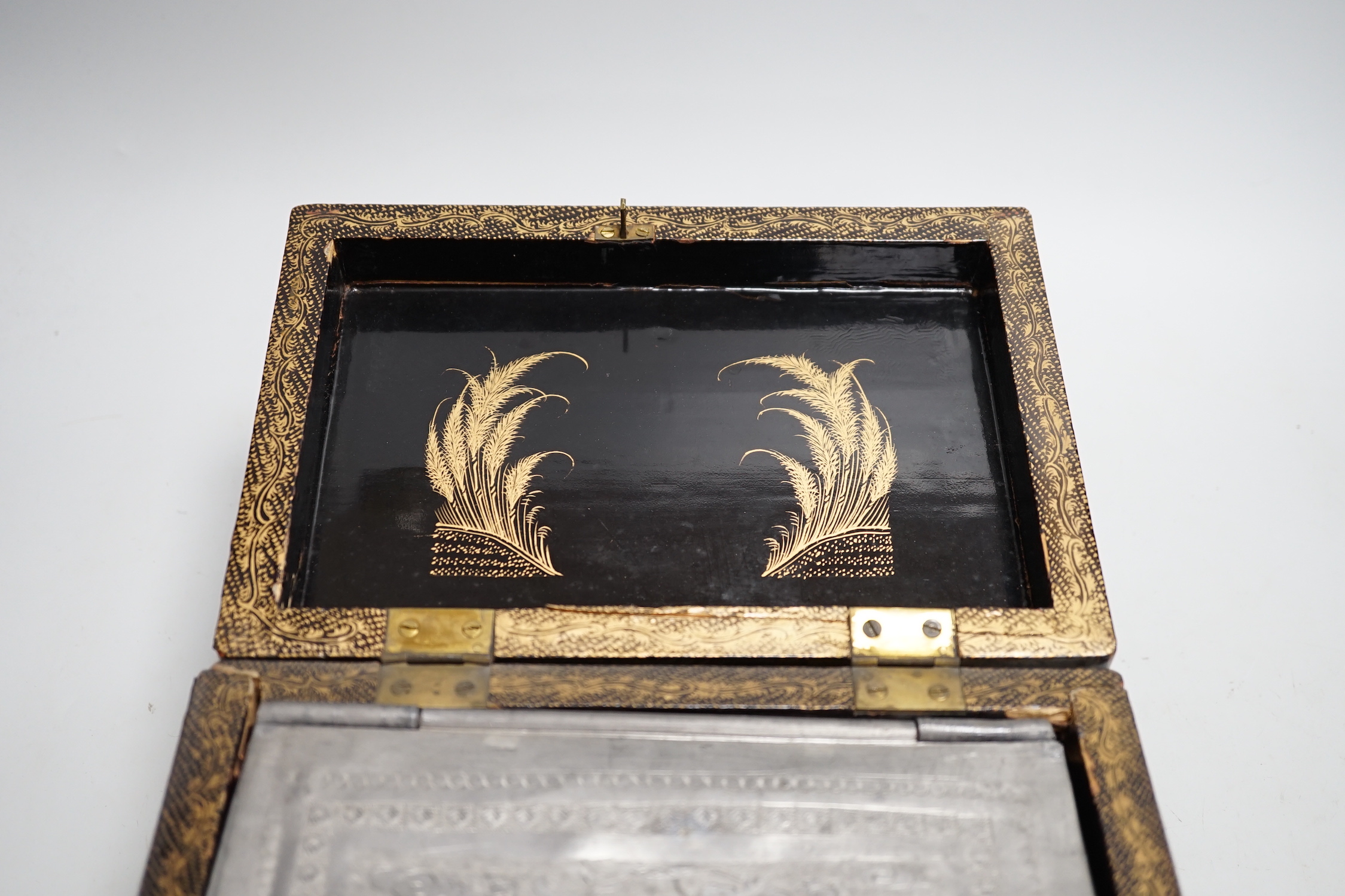 A 19th century Chinese export lacquer tea caddy, black ground with gilt decoration, containing a separate lidded pewter lining box with engraved decoration, 23cm x 16cm x 12cm